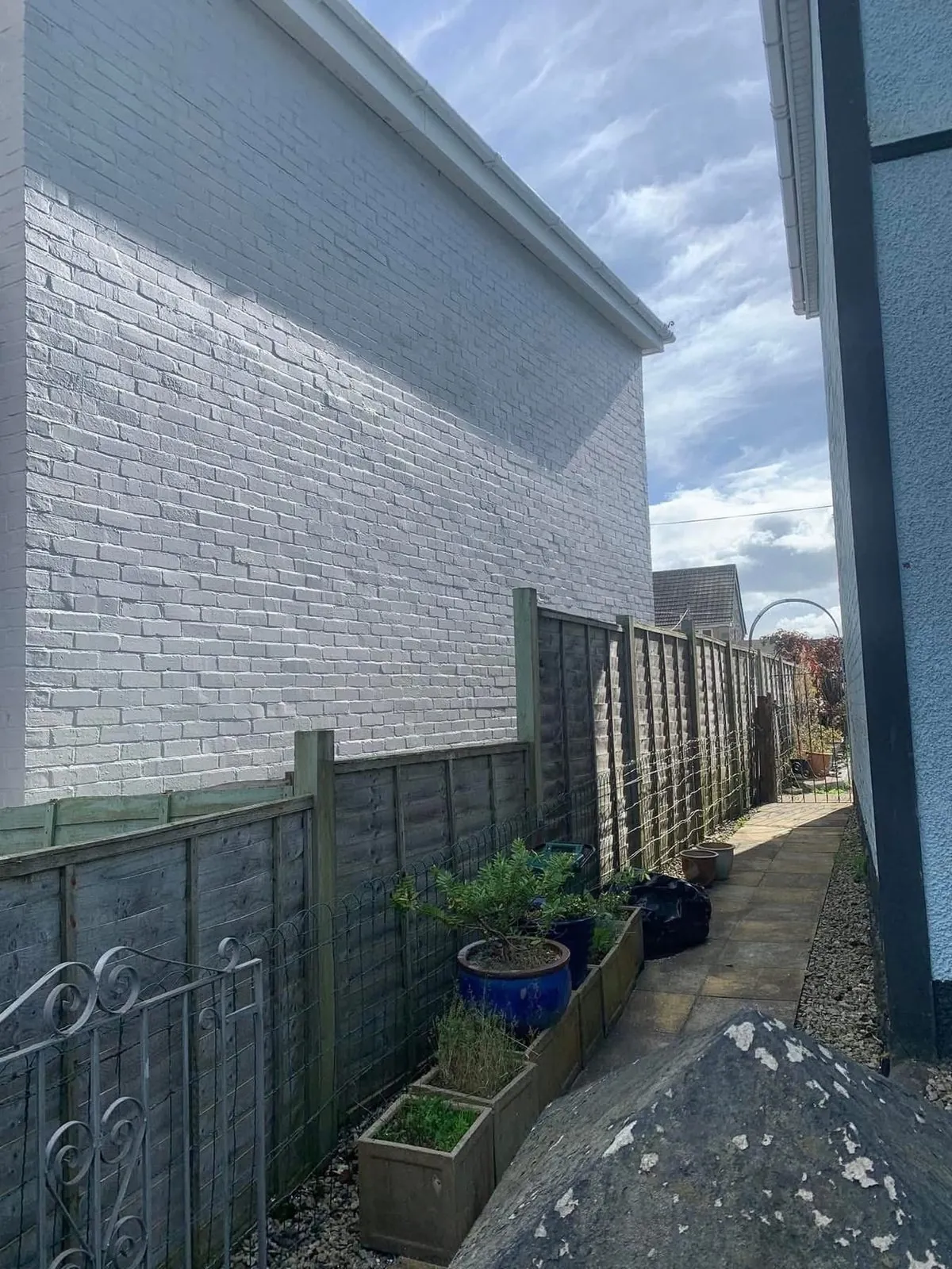 Freshly painted brick wall after preparation and masonry paint in Penzance